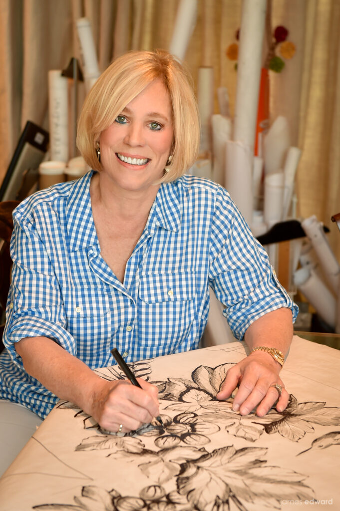 Lynn Sears smiling while working on a design for a project